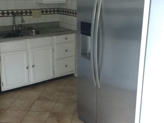 Kitchen with incuded appliances of refrigerator, stove and o