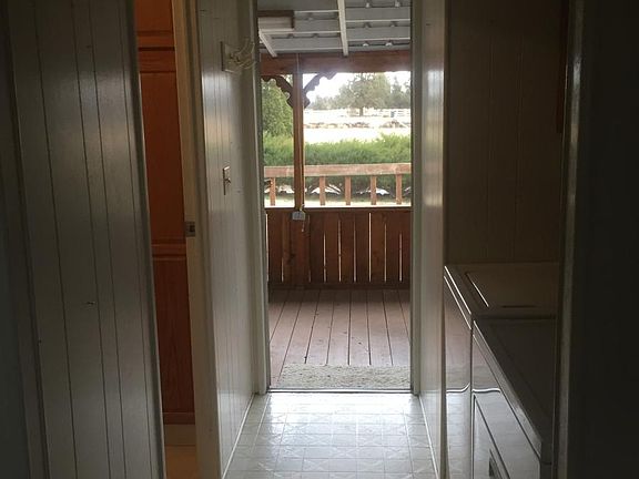 Back door looking into covered deck and back of 5 acres