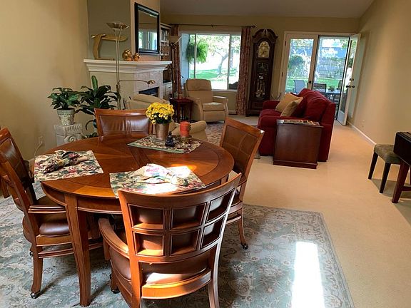 View from the kitchen to the dining and living areas with the back porch beyond.