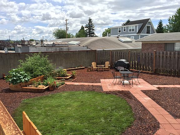 Private back yard with common areas and planting beds