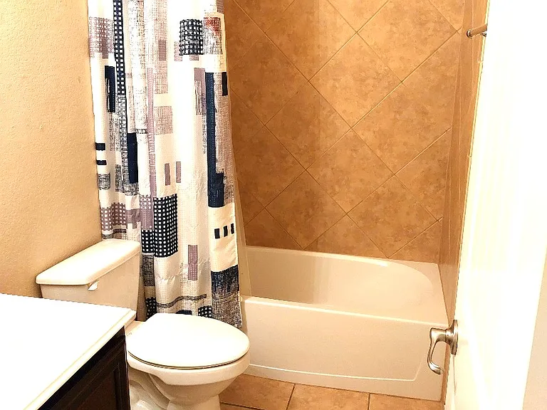 2nd bath located between two secondary bedrooms.