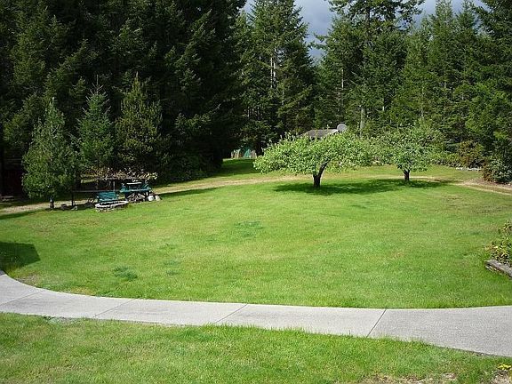 Apple trees, fire pit, green house, horse shoe pit, detached 1 car garage.
