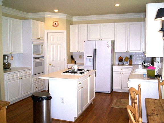 Nice kitchen with island and solid surface countertops 