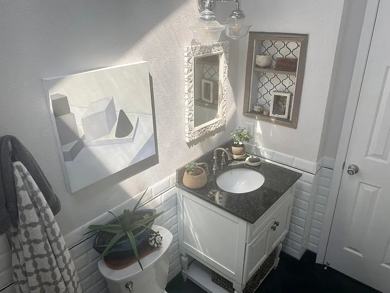 Bathroom with vaulted ceiling and amazing skylight...lighting changes throughout the day and sometimes you can peek the full moon in the evening!