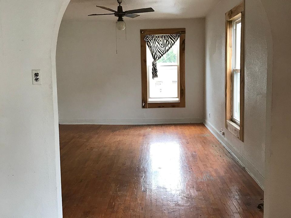 This arch way leads from the dining room into the living room. Entry door is to the right.
