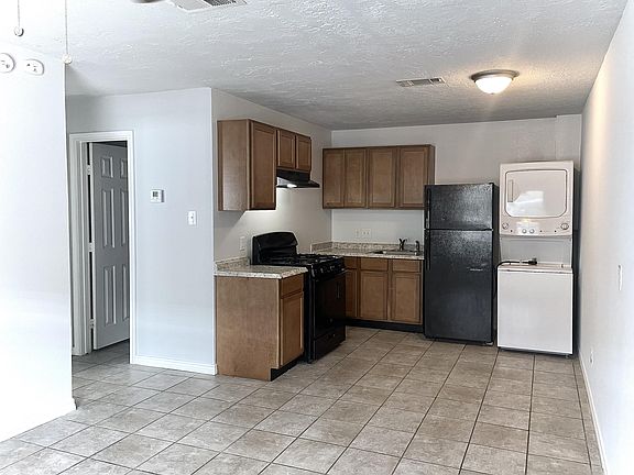 Kitchen; from this view, you can see the door to one of the bedrooms.