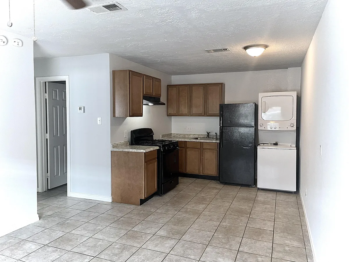 Kitchen; from this view, you can see the door to one of the bedrooms. - 1906 Finfeather Rd
