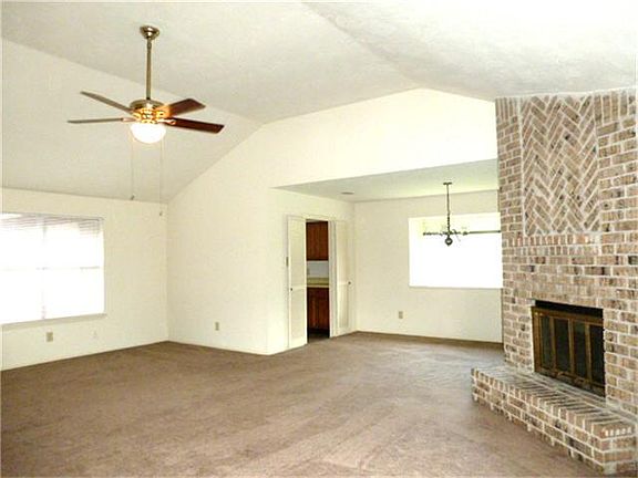 View across the family room toward the dining room and kitchen.
