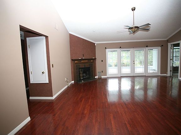 Great Room with Wood Fireplace and Oak Floors throughout, French doors to pool