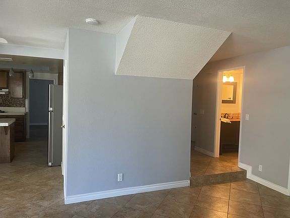 Den with view of kitchen and downstairs bathroom