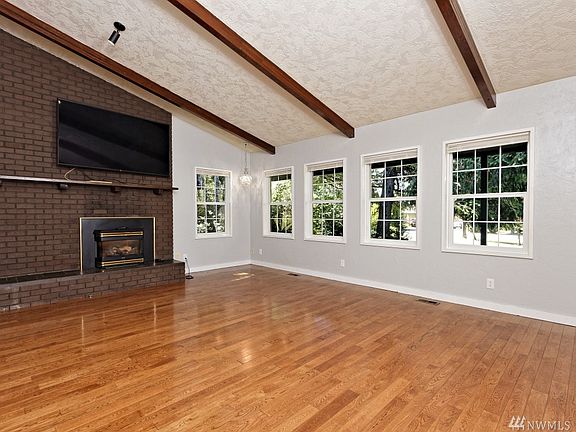 Step down into this huge living room with a natural gas fireplace and REAL hardwood floors!