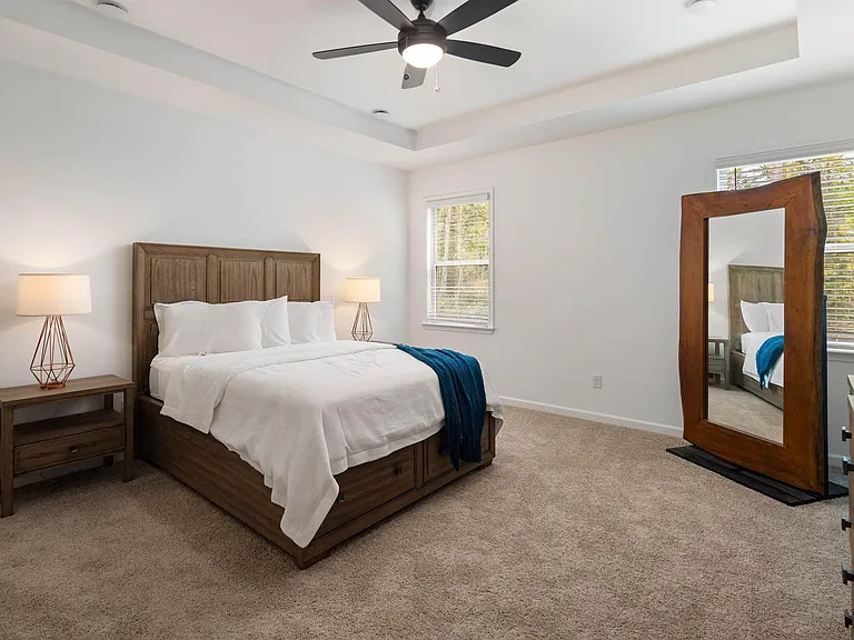 Primary Bedroom with king size bed and large window letting in nice natural light.