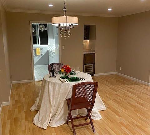 Dining room with dry bar and built-in wine fridge in background.
