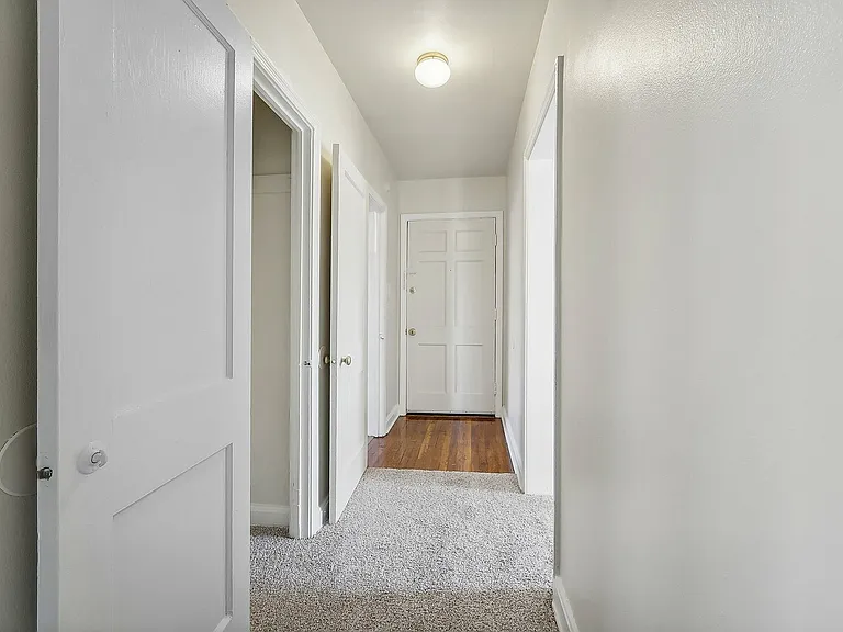 Step into a welcoming entrance, featuring bright walls and soft carpets.