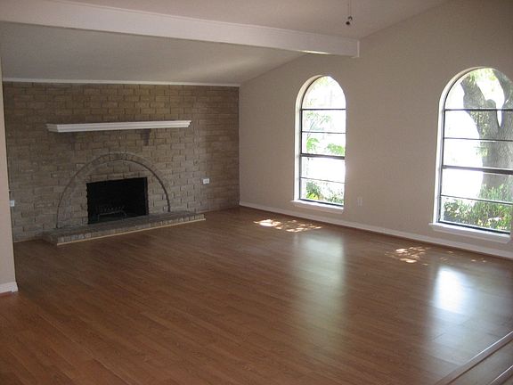 Familyroom features a wood burning fireplace and double doors to covered porch