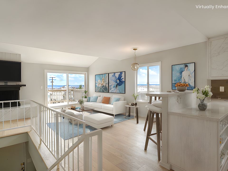 Great ocean views and open layout that flows to a balcony. The property is unfurnished - this photo is virtually staged.