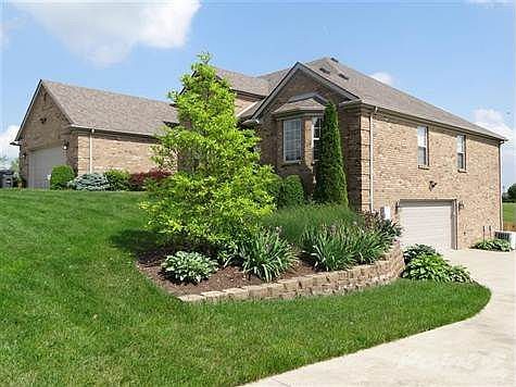 Custom brick ranch-style home. For the avid fisherman, woodworker, or car enthusiast, this home offers two large garages.