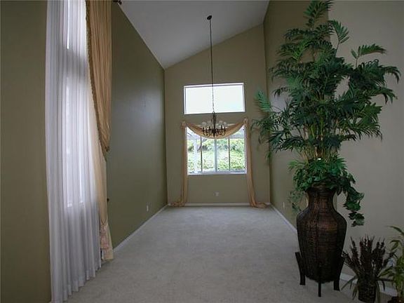 Living Room with high ceiling; there will be new flooring for the living room, study room and casitas downstairs as well as all the upstairs