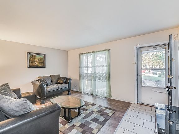 Unit 1: Generous sized Family Room with wood laminate flooring