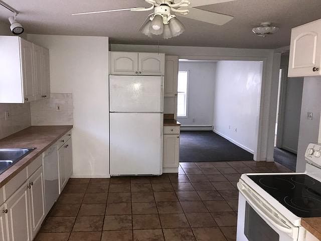 Large eat-in kitchen w/lots of cabinets and counter space with ceramic tile floor.