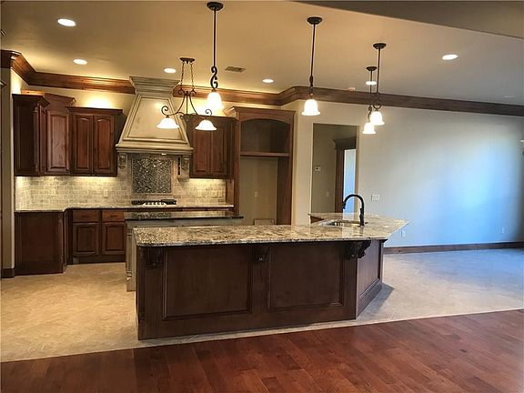 Beautiful granite and tile work in this open and elegant kitchen.
