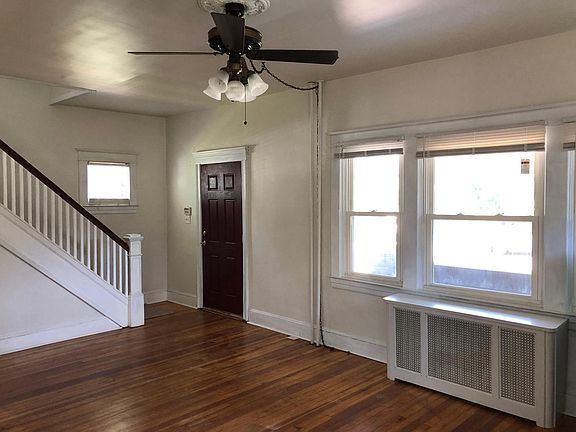 Living room with ceiling fan, refinished hardwood floors