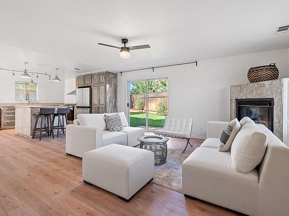 Open floor living with sliding doors out to the yard. Gas Fireplace.
