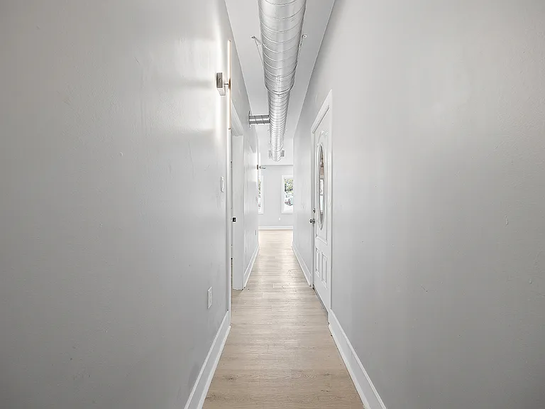 Hallway looking towards open concept kitchen/living/dining room