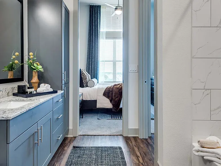 Griffis Frisco apartment bathroom with wood style floor.