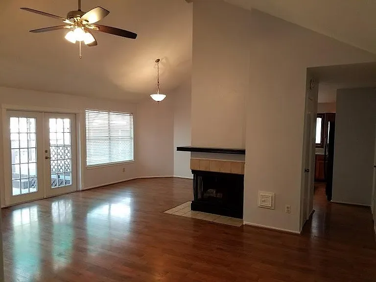 Den with space for dining table off to the left, entrance to kitchen to the right