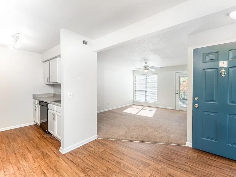 Open Living Area with Chestnut Wood-Style Flooring and Bright Natural Light - Gold Interior