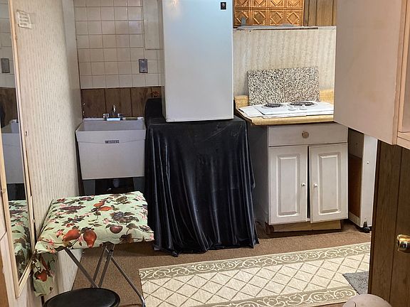 Kitchenette, cook ability with refrigerator and sink space for small table cabinets