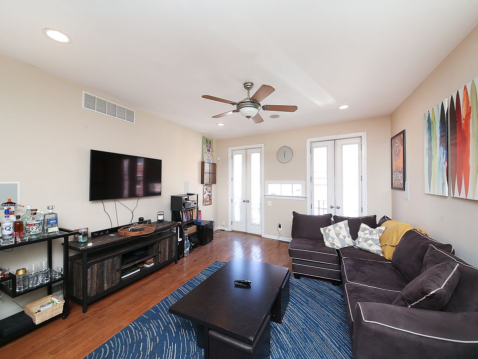 open plan floor concept with main living room into large kitchen and breakfast bar; access to front balcony overlooking the Italian Market that is 1/2 a block away