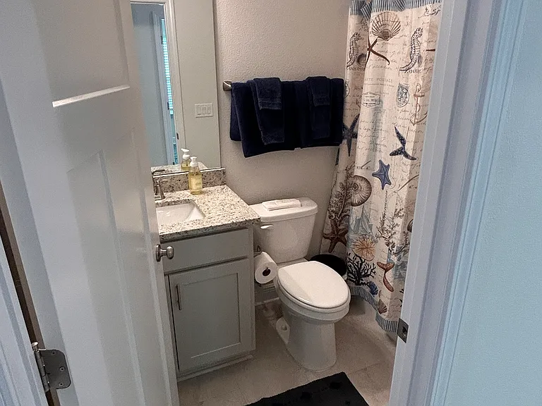 Hall bath with tub shower combination and linen closet