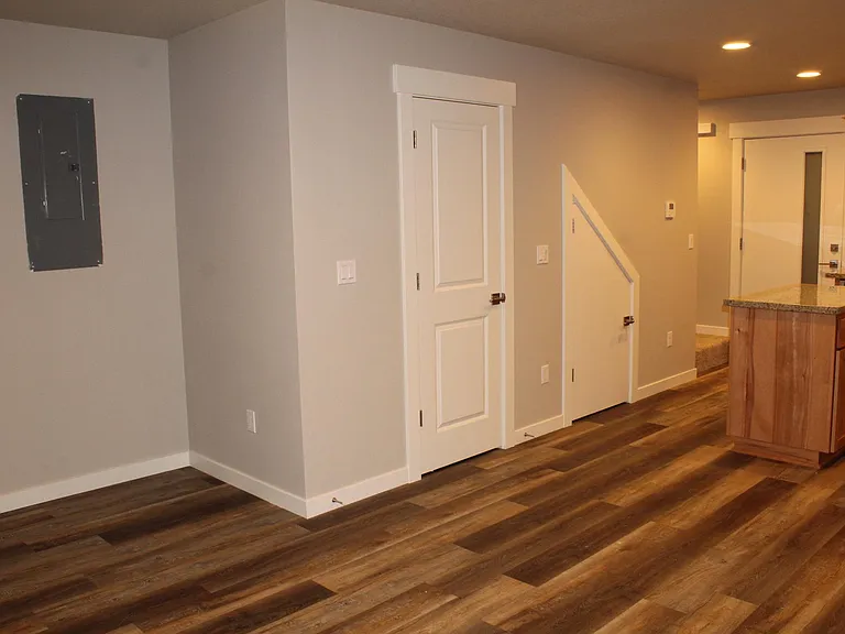 View from Great Room towards Nook, Kitchen, 1/2 Bath, Under Stairs Storage and Entryway