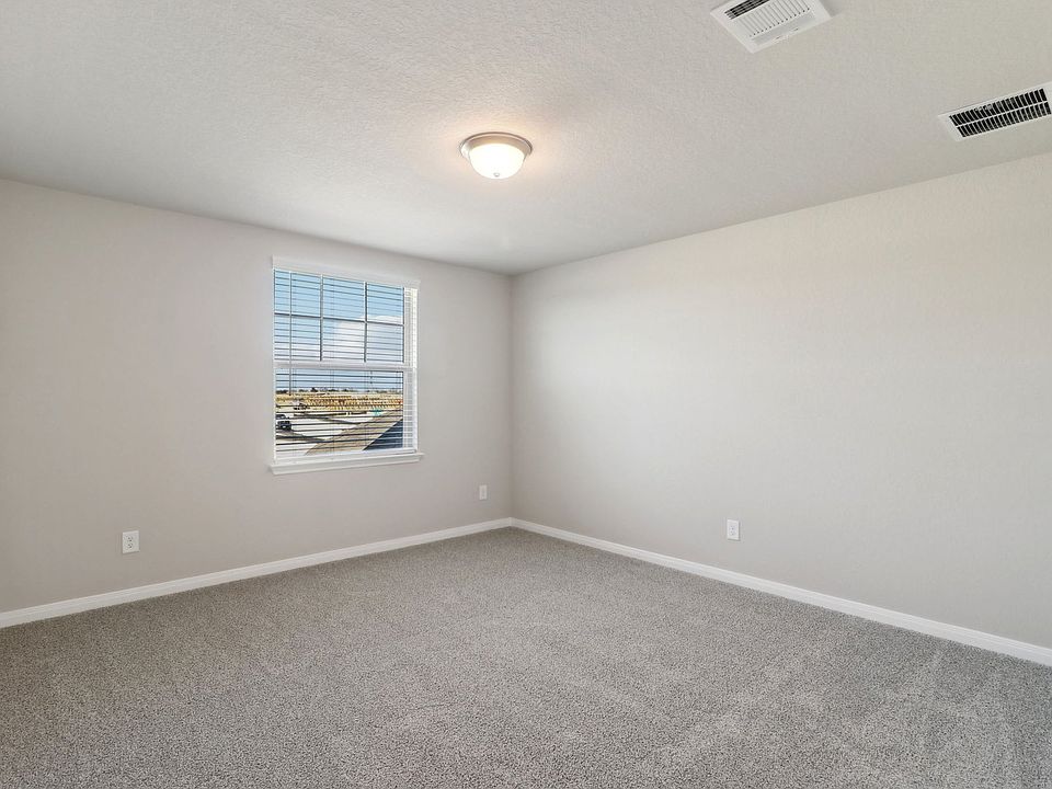 Guest bedroom in the Pearl floorplan at a Meritage Homes community.