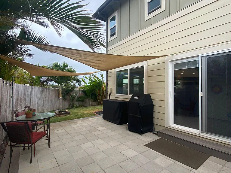 Side yard w/ fire pit and outdoor sink (grill and furniture pictured are no longer present)