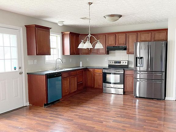 Eat in kitchen with new stainless steel appliances.