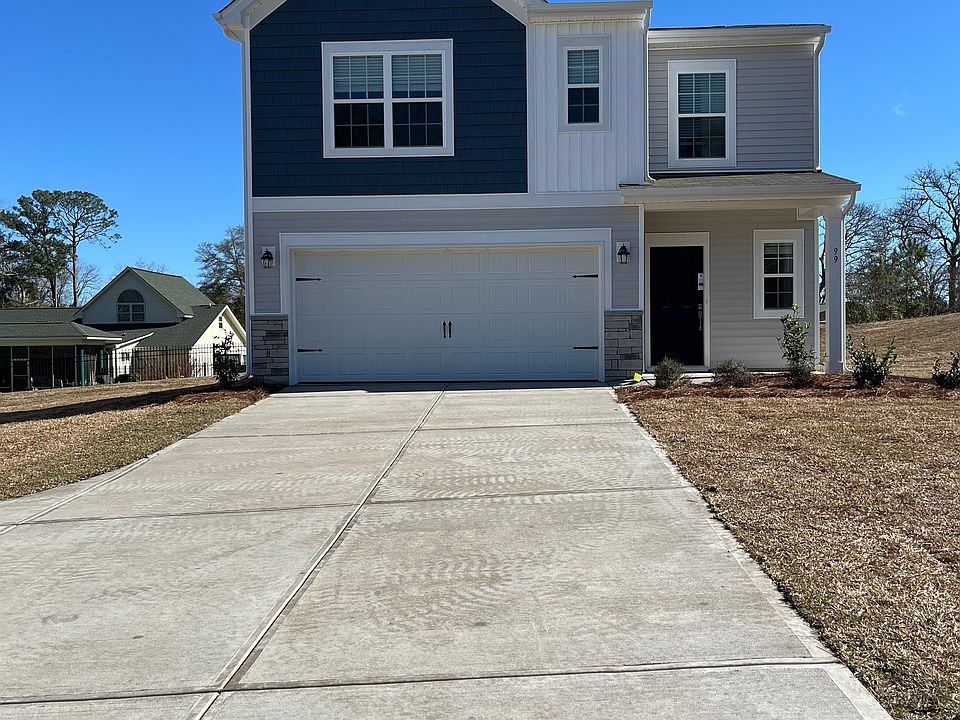 Huge driveway leading to 2 car garage for extra parking spaces .
