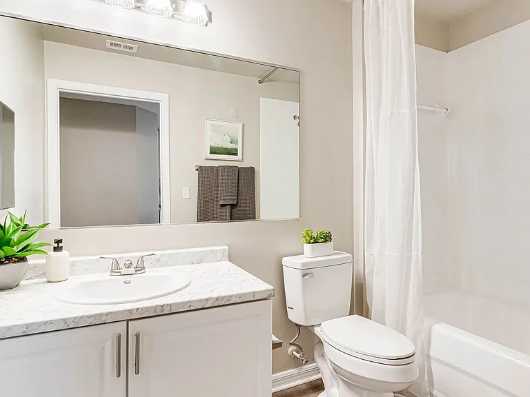 Our primary bathrooms feature oversized mirrors and optimized storage.