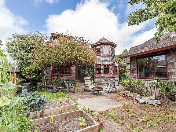 Backyard. Raised beds for gardening. Patio off 2nd bedroom, center.