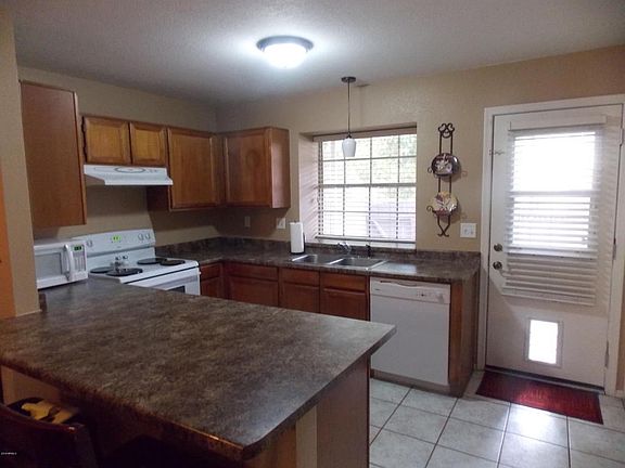KITCHEN WITH NEWER COUNTER TOPS.