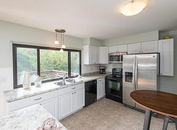 Brightly updated kitchen...new cabinets, flooring, appliances, hardware, lighting, countertops and a pantry