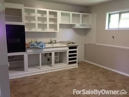 Kitchen
						:
						Cabinets doors are missing in this photo.