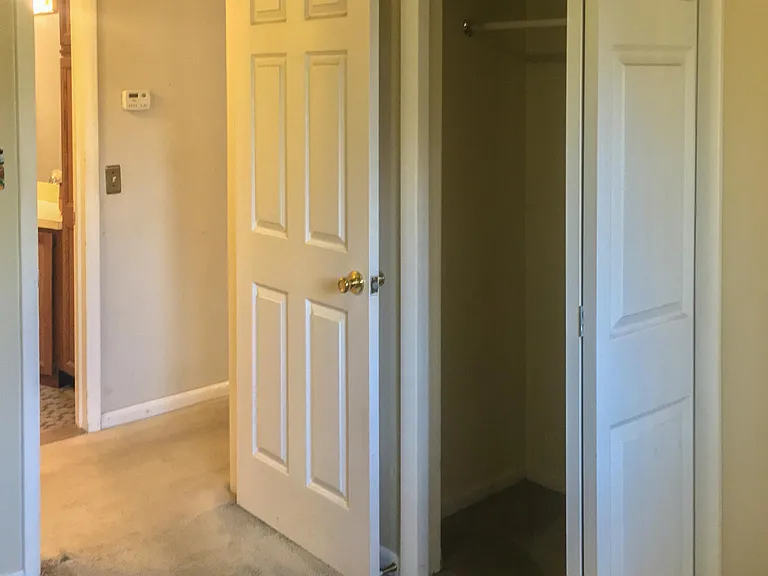 2nd Bedroom, view accross hallway into 2nd bath, on the right closes with folding door