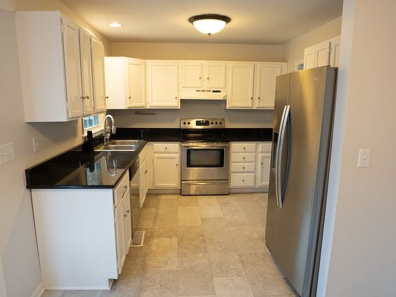 Functional kitchen that looks out to the fenced in backyard