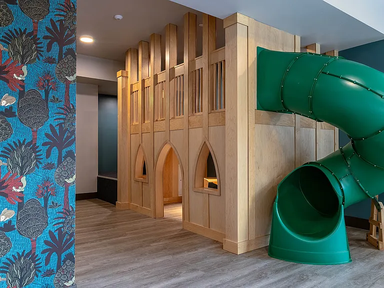 Wooden castle play area in East Building Free Play amenity