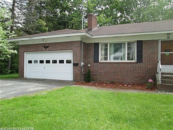 Front.  The home can also be entered through the two-car attached garage, with a door leading into the Den area.