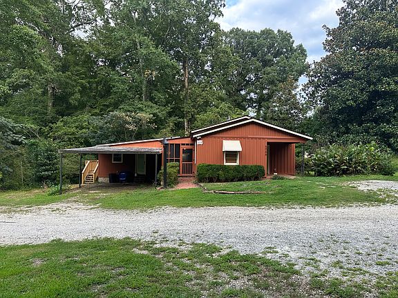 Side View, Carport for one parking spot. The left unit is separate and not included in the listing.