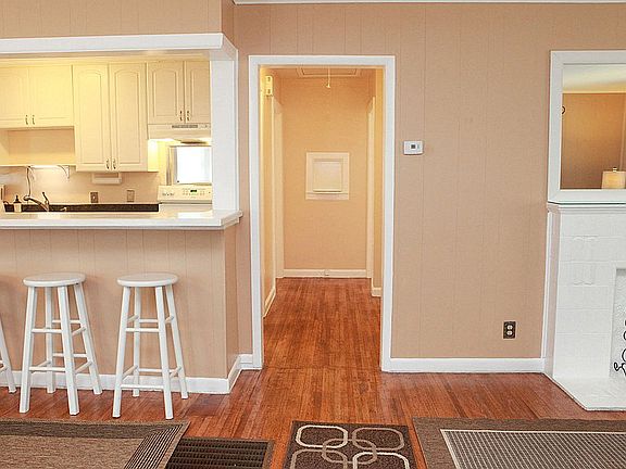 An open floor plan greets you from the front door with the living room on the right, dining area on the left, and kitchen straight ahead.